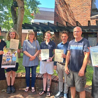 Freuten sich über die Auszeichnung: Jonatan Oltzscher (links neben Amtsdirektorin Juliane Bohrer), Ann-Christin-Ewoldt (Mitte), das Team der Wagengruppe Blaulicht sowie Kerstin Nickstadt von der Heinrich-Heine-Schule (rechts). 